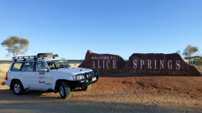 Survey car parked in front of the Welcome to Alice Springs sign